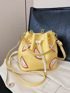 Chic yellow bucket bag featuring watermelon embroidery and drawstring closure detail