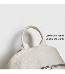 Detail of white litchi grain leather backpack with sturdy handle and silver metal zipper
