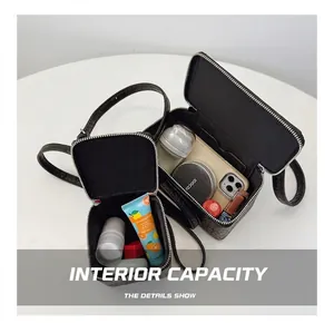 Detailed view showing the internal capacity and compartmentalization of black vanity bags