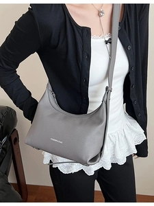 Gray litchi grain leather hobo bag with adjustable strap and front logo print