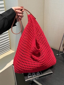 Large red hollow woven tote bag with brown handles for summer beach vacation use
