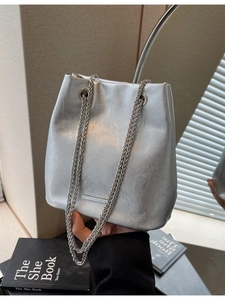 Silver metallic bucket bag with crinkled faux leather texture and dual chain straps