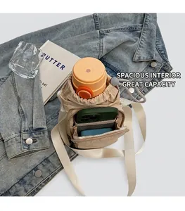 Detail showing inner capacity for water bottle and smartphone in beige nylon crossbody bag