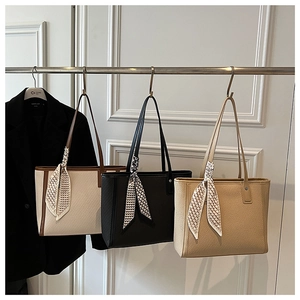Three textured tote bags in beige, black and khaki with decorative silk scarves