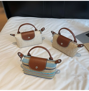 Detailed close-up of handmade straw bags with leather handles and zip closures