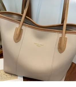 Detail of soft leather tote bag with Fashion Trend gold lettering and contrast piping