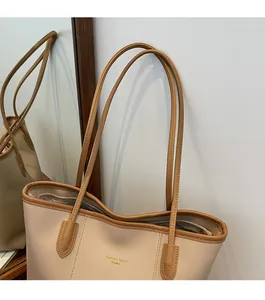 Close-up of comfortable shoulder straps on a beige and brown vintage tote bag
