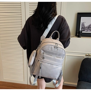 Detail of lavender faux leather backpack with pebble texture and detachable coin purse