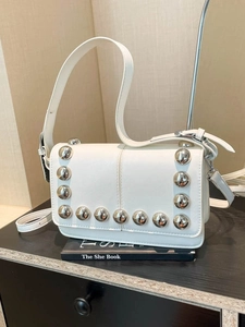 Chic cream white crossbody bag with polished metal rivets and adjustable strap