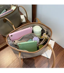 Detailed interior of large beige tote bag showing spacious compartments and storage