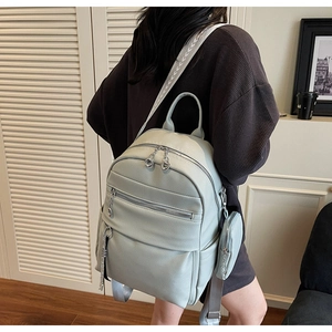 Detail view of mint green lychee grain leather backpack with geometric pattern straps