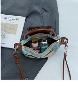 Macro view of woven straw bag interior space with contrast stripes and leather strap
