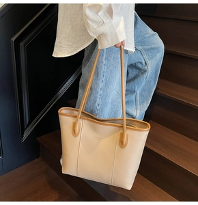 Detail of vintage tote bag with contrast brown straps and Fashion Trend Boutique text