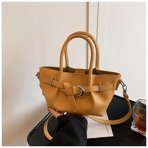 Détail du sac seau en similicuir jaune moutarde avec boucle argentée et bandoulière