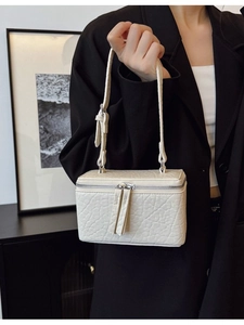 Fashionable creamy white textured box bag with adjustable handle and silver zippers