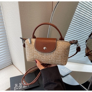 Macro detail of the handwoven texture and premium leather flap closure on the mini straw bag