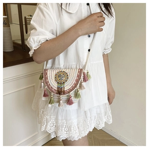 Close-up of Bohemian hand-woven crossbody bag with colorful ethnic embroidery and fringe