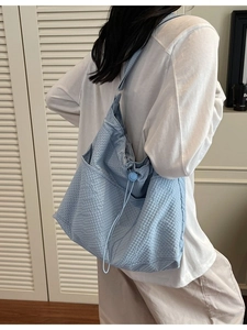 Light blue waffle texture tote bag for daily commute shown in a stylish side view