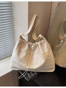 Minimalist cream waffle texture tote bag with drawstring closure and large front pockets