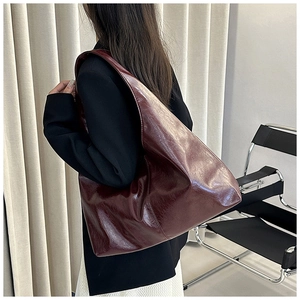 Dunkelweinrote Hobo-Tasche an der Schulter eines Models für realistische Größenreferenz