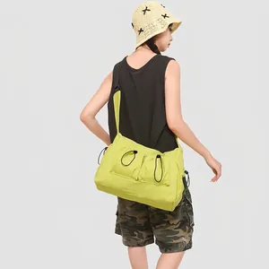 Detail of lime green nylon crossbody bag showing the drawstring design and strap