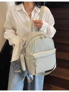 Minimalist mint green faux leather backpack with matching coin purse for stylish commuting