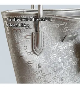 Detail shot of silver tote bag featuring numeric prints and neat stitching craftsmanship