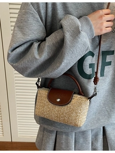 Handmade straw crossbody bag with brown leather accents for beach vacation style