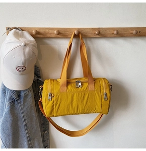 Hanging bright yellow nylon travel bag with dual zippers and adjustable shoulder strap