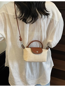 Handmade woven straw crossbody bag with brown leather flap for summer beach vacations