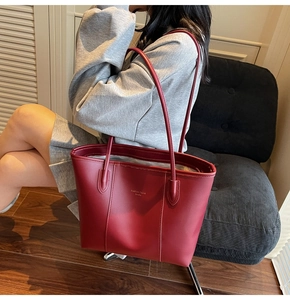 Close-up of a large vintage red tote bag with durable texture and long shoulder straps