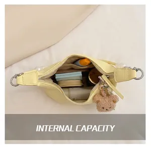 Interior view showing the large capacity of a yellow crossbody bag with daily essentials