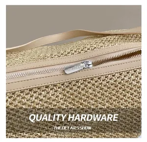 Macro detail of high-quality metal zipper and hand-woven straw texture on a tote bag