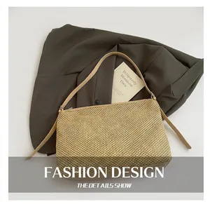 Macro detail showing woven straw texture and premium leather strap of the tote bag