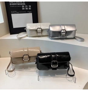 Detail shot of rectangular shoulder bags in white, silver, apricot, and black faux leather