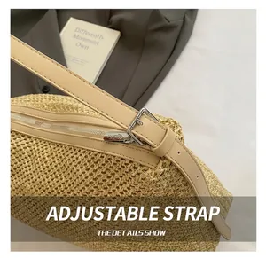 Detail of adjustable beige leather strap and woven texture on straw tote bag