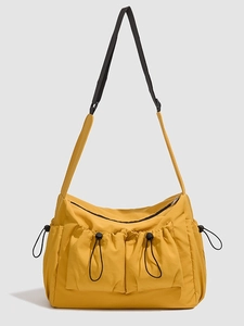 Large mustard yellow nylon tote bag with functional pockets and adjustable shoulder strap