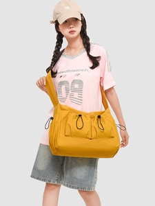 Large yellow canvas crossbody bag with drawstring pockets, ideal for students and daily casual use