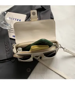 Internal view of cream crossbody bag showing spacious compartments and storage capacity
