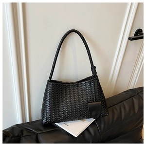 Detail of black woven leather shoulder bag showing intricate Intrecciato craft and texture