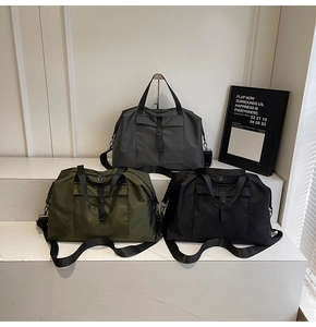 Three travel bags in grey, green, and black, showcasing large capacity and waterproof nylon fabric