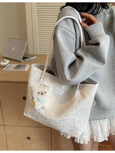 White large capacity tote bag with grey numeric print and cute plush bear charm for daily commute