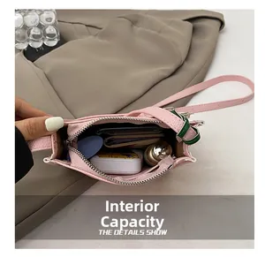 Detail view of pink bucket bag interior capacity showing phone and wallet storage