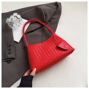 Close-up of red woven hobo bag detail showing intricate Intrecciato leather texture