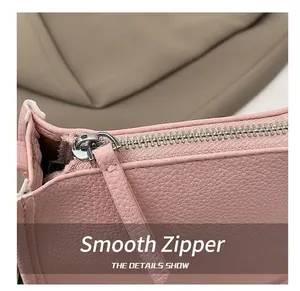 Close-up of pink lychee grain leather bucket bag with premium silver zipper detail