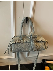 Light blue denim Y2K hobo bag with large bow and silver studs, top handle style
