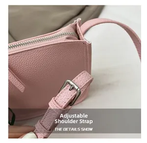 Detail of pink lychee texture shoulder bag showing adjustable strap and metal buckle