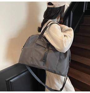 Macro shot of durable grey travel bag featuring adjustable buckle strap and metal hardware