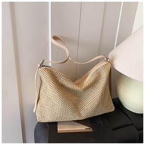 Vue détaillée de la texture en paille tressée et fermeture éclair de ce sac hobo