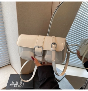Detailed macro view of the cream white shoulder bag featuring a glossy PU leather texture